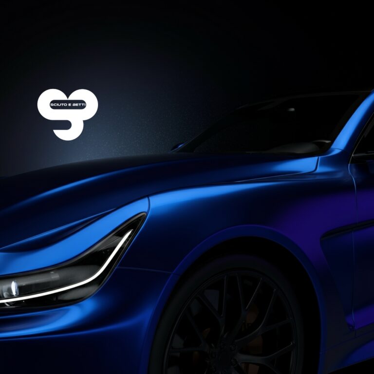 CARROZZERIA SCIUTO - Verniciatura auto a Grosseto - A close-up of a blue car's hood and headlight, with SCIUTO logo above.