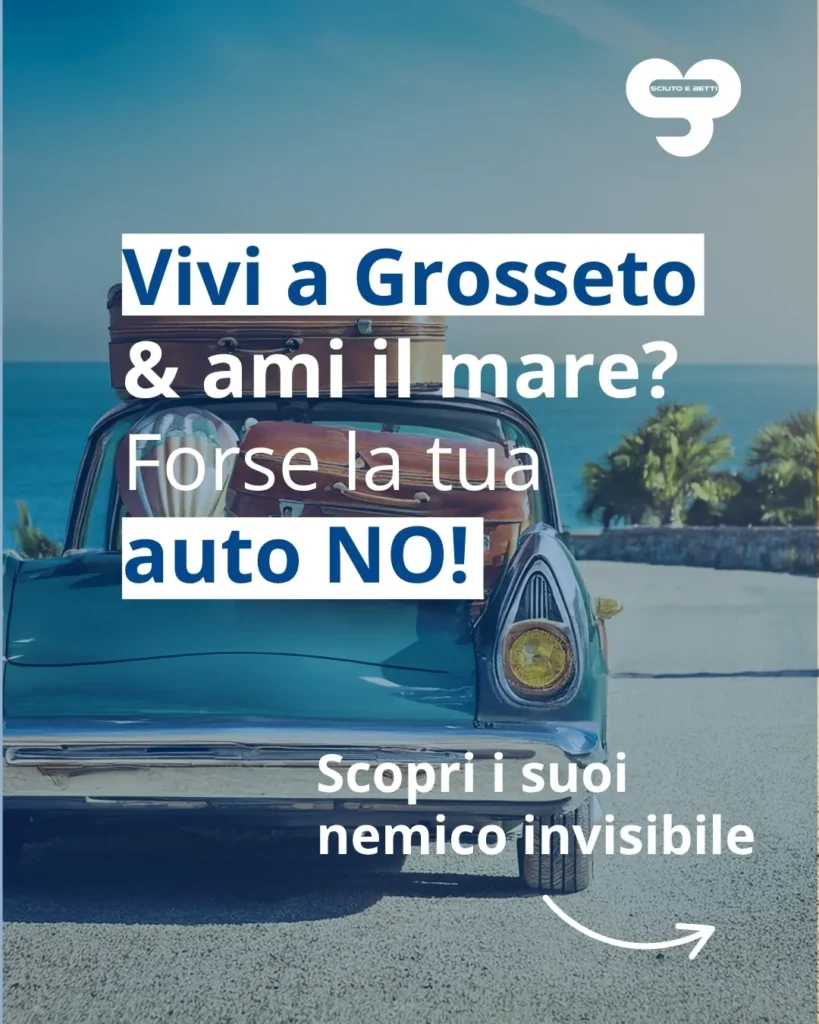 SCIUTO - A classic blue car parked near the beach with suitcases on top and ocean in the background.